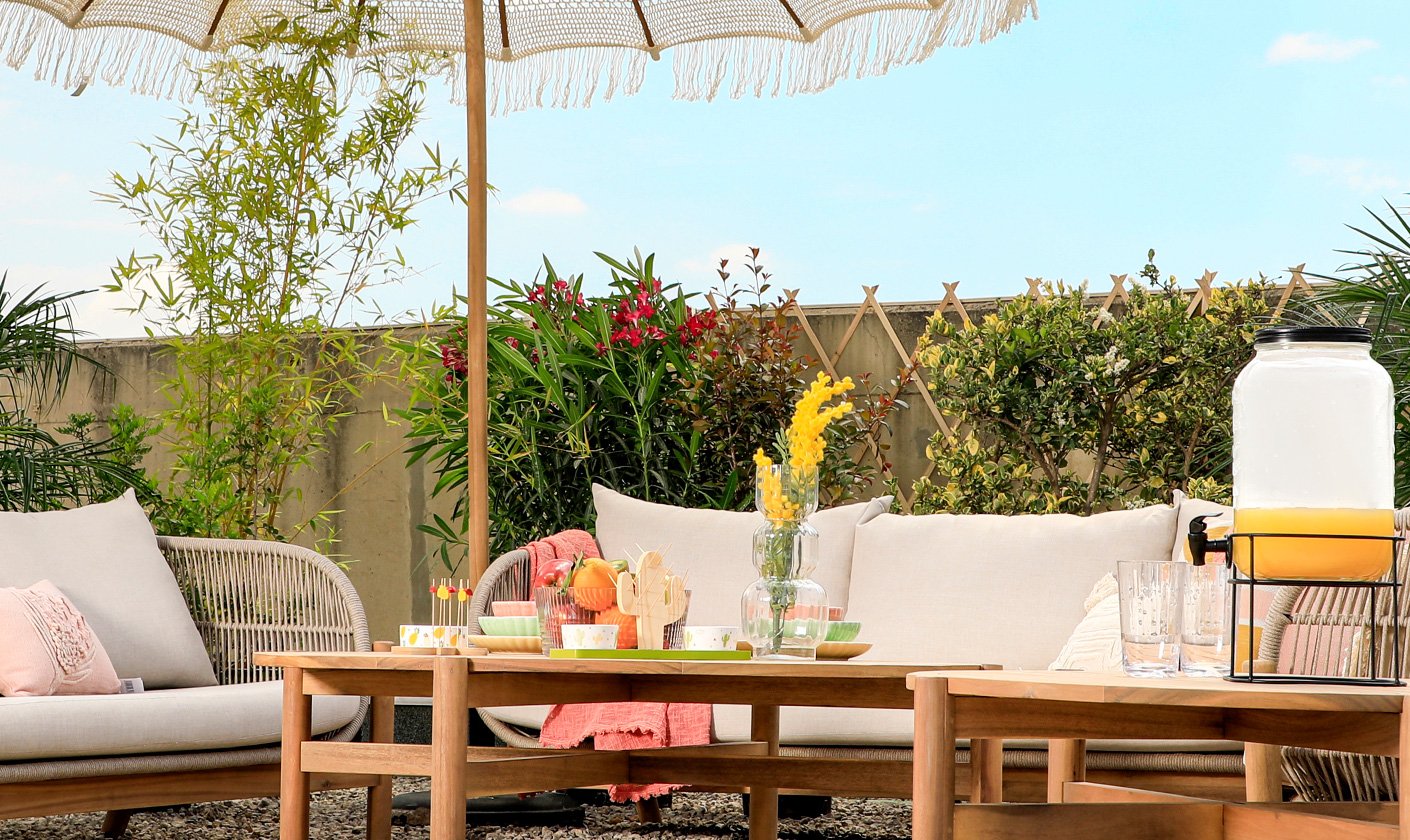 Transform your backyard into an outdoor escape with cozy furniture and serene accents.